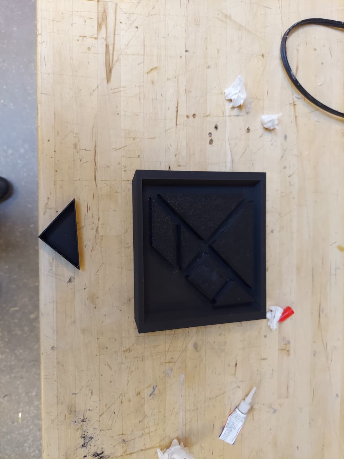 3D printed tangram pieces glued into a square frame
